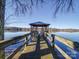 Wooden dock with gazebo offering scenic lake views at 168 Tanglewood Cv, Belmont, NC 28012