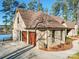 Three-car garage with wood doors, located on a waterfront property at 168 Tanglewood Cv, Belmont, NC 28012