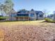 Brick house with a large deck and screened porch, nestled in a wooded area at 168 Tanglewood Cv, Belmont, NC 28012