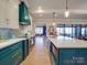 Modern kitchen with teal cabinets and a large island at 168 Tanglewood Cv, Belmont, NC 28012