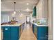 Modern kitchen with teal cabinets and a large island at 168 Tanglewood Cv, Belmont, NC 28012