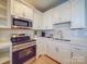 Modern kitchen with white cabinets and stainless steel appliances at 168 Tanglewood Cv, Belmont, NC 28012