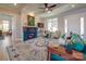 Living room with a teal sofa, fireplace, and access to a screened porch at 168 Tanglewood Cv, Belmont, NC 28012