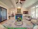 Living room featuring a fireplace, large windows, and access to the Primary bedroom at 168 Tanglewood Cv, Belmont, NC 28012