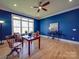 Home office with blue walls, hardwood floors, and large window at 168 Tanglewood Cv, Belmont, NC 28012