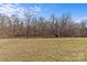 Wide open backyard of home with trees and an open lawn at 2050 Stoney Creek Nw Dr, Concord, NC 28027