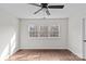 Simple bedroom with hardwood floors and large windows at 2050 Stoney Creek Nw Dr, Concord, NC 28027