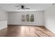 Spacious bedroom featuring hardwood floors and a large window at 2050 Stoney Creek Nw Dr, Concord, NC 28027