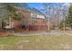 Exterior view of the brick home with a spacious deck and stone patio at 2050 Stoney Creek Nw Dr, Concord, NC 28027