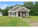 Charming one-story house with gray siding, black shutters, and a welcoming porch at 209 S Gregory St, Lancaster, SC 29720