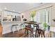 Modern kitchen with white cabinets, granite countertops, and island seating at 209 S Gregory St, Lancaster, SC 29720