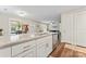 Modern kitchen with white cabinets, granite countertops, and island seating at 209 S Gregory St, Lancaster, SC 29720