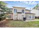 Spacious backyard featuring a patio, lush lawn, and charming two-story home with large windows at 2327 Axford Ln, Matthews, NC 28105