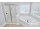 Bathroom featuring a shower, garden tub and natural light at 2327 Axford Ln, Matthews, NC 28105