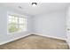 Bedroom featuring white trim, carpeted floors, and natural light at 2327 Axford Ln, Matthews, NC 28105