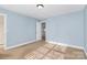 Bedroom featuring blue walls, carpeted floors, a door to hallway and natural light at 2327 Axford Ln, Matthews, NC 28105