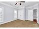 Bedroom featuring carpeted floors, white trim, and a double door closet at 2327 Axford Ln, Matthews, NC 28105