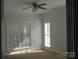 Bedroom with neutral walls, carpeted floors, and large windows at 2327 Axford Ln, Matthews, NC 28105