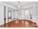 Dining room featuring hardwood floors, large windows, elegant pillars, and modern lighting at 2327 Axford Ln, Matthews, NC 28105