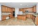 Kitchen featuring wooden cabinets, a center island, tile flooring, and stainless steel microwave at 2327 Axford Ln, Matthews, NC 28105