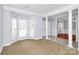 Living room featuring a bay window, carpet, and decorative columns to the entry way at 2327 Axford Ln, Matthews, NC 28105