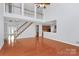 Spacious living room featuring hardwood floors, a staircase, and a view of the upstairs landing at 2327 Axford Ln, Matthews, NC 28105