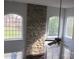 Living room featuring stone fireplace, hardwood floors, and arched windows at 2327 Axford Ln, Matthews, NC 28105