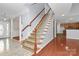 View of the staircase in a home featuring hardwood and tile floors and neutral paint at 2327 Axford Ln, Matthews, NC 28105