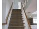 Carpeted staircase with white railing and wood trim, leading to the upper level at 2327 Axford Ln, Matthews, NC 28105