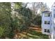 Exterior building elevation with lawn, mature trees and landscaping at 2501 Roswell Ave # 303, Charlotte, NC 28209