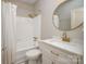 Bright bathroom featuring updated vanity with stone countertop and gold hardware at 2501 Roswell Ave # 303, Charlotte, NC 28209