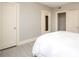 Bedroom with light gray walls, hardwood floors, and an ensuite bathroom with a full-length mirror on the door at 2501 Roswell Ave # 303, Charlotte, NC 28209