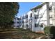 Exterior elevation of building showcasing unit windows, lawn and surrounding trees at 2501 Roswell Ave # 303, Charlotte, NC 28209