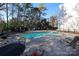 Outdoor community pool area with mature trees, fencing and lounge chairs and tables at 2501 Roswell Ave # 303, Charlotte, NC 28209