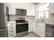 Updated kitchen featuring stainless steel appliances and white cabinets at 2501 Roswell Ave # 303, Charlotte, NC 28209