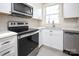 Modern kitchen featuring stainless steel appliances, white cabinets, and updated countertop at 2501 Roswell Ave # 303, Charlotte, NC 28209