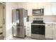 Renovated kitchen with stainless steel appliances and white shaker cabinets at 2501 Roswell Ave # 303, Charlotte, NC 28209