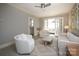 Bright and airy living room with neutral tones, plush seating, and French doors leading to a sunlit area at 2501 Roswell Ave # 303, Charlotte, NC 28209