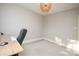 Minimalist office space with light walls, hardwood floor and wooden desk with a black computer chair at 2501 Roswell Ave # 303, Charlotte, NC 28209