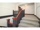 Staircase with gray patterned carpet, dark wood trim and painted white walls at 2501 Roswell Ave # 303, Charlotte, NC 28209