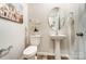 Charming powder room featuring a pedestal sink, oval mirror, and wood-look flooring at 252 Laura Elizabeth Ln, Clover, SC 29710