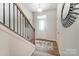 Inviting foyer with wood floors, staircase, stylish mirror, and a well-lit front door showcasing modern design at 252 Laura Elizabeth Ln, Clover, SC 29710