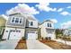 Charming townhomes featuring attached garages and welcoming curb appeal with manicured landscaping under a bright sky at 252 Laura Elizabeth Ln, Clover, SC 29710