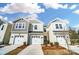 Charming townhomes featuring attached garages and welcoming curb appeal with manicured landscaping under a bright sky at 252 Laura Elizabeth Ln, Clover, SC 29710