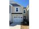 Beige two-story townhome with white garage door and landscaping at 252 Laura Elizabeth Ln, Clover, SC 29710