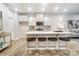 Bright kitchen features white cabinets, an island with stool seating, and modern pendant lighting at 252 Laura Elizabeth Ln, Clover, SC 29710