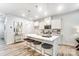 Bright kitchen features white cabinets, an island with stool seating, and modern pendant lighting at 252 Laura Elizabeth Ln, Clover, SC 29710