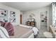 Bedroom featuring plush bedding, white walls, decorative art, and a view to a large walk-in closet at 260 Laura Elizabeth Ln, Clover, SC 29710