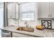 Modern kitchen sink with stainless steel faucet, granite countertops, and white subway tile backsplash at 260 Laura Elizabeth Ln, Clover, SC 29710