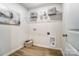 Efficient laundry room with wooden floors, white walls, wire shelves and a wooden basket, designed for convenience at 260 Laura Elizabeth Ln, Clover, SC 29710